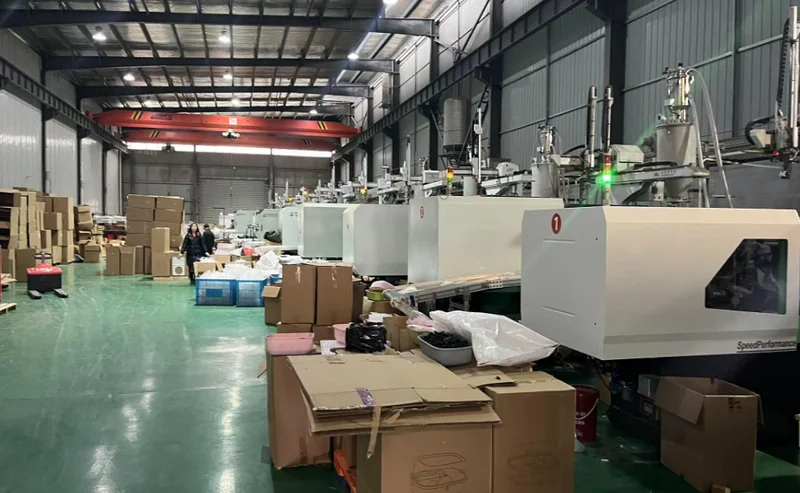 Large injection molding — heavy-duty injection machines with raw materials in production workshop