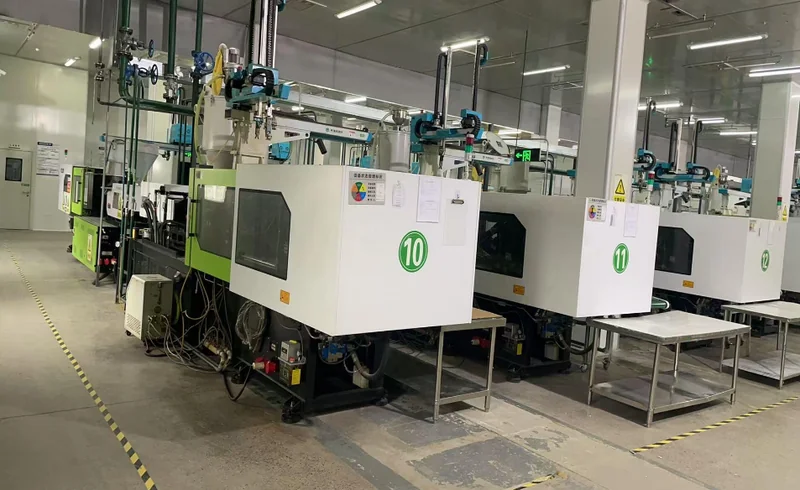 Injection molding — series of plastic injection molding machines numbered 10/11/12 in production hall