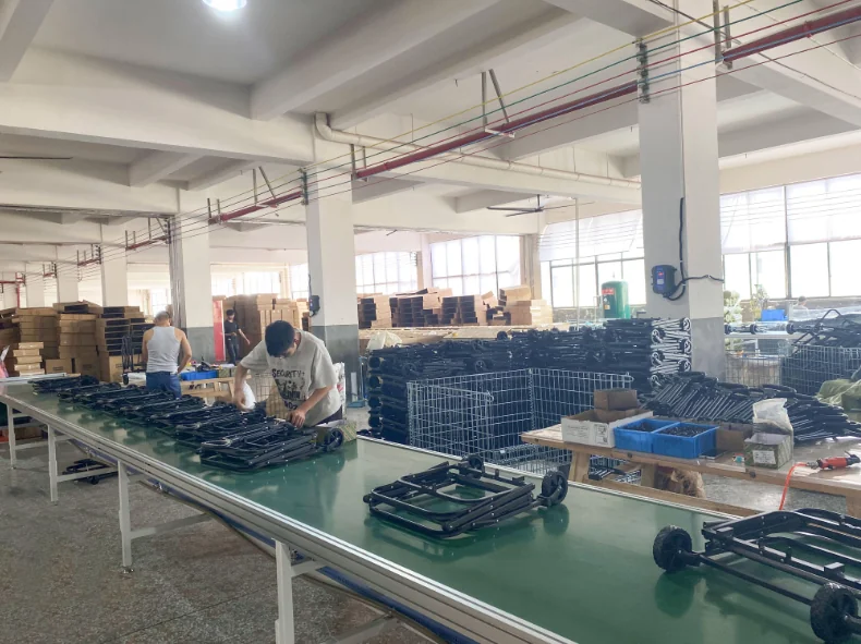 Storage & trolley assembly — workers assembling rolling storage trolleys in well-lit workshop