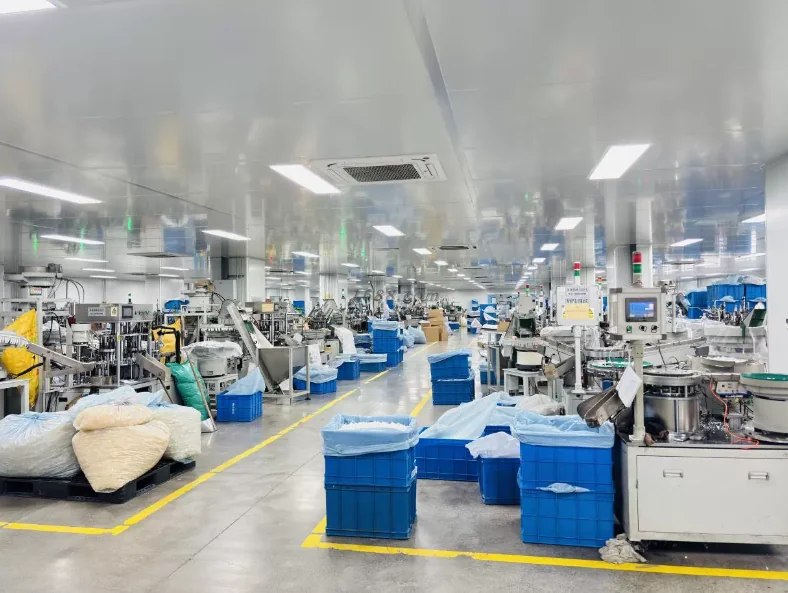 Assembly & packaging line — workers at conveyor lines producing and packing finished goods